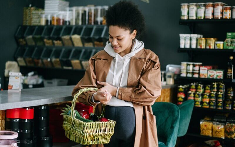 Pregnant Woman Holding Basket with Groceries
