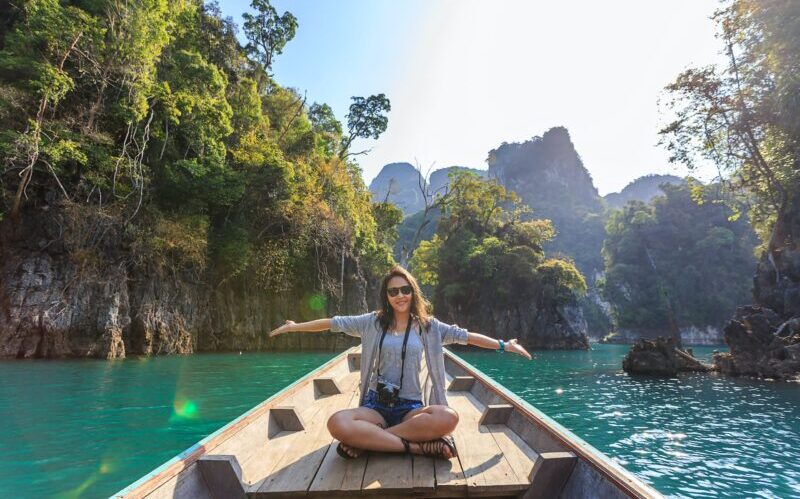 Photo of Woman Sitting on Boat Spreading Her Arms