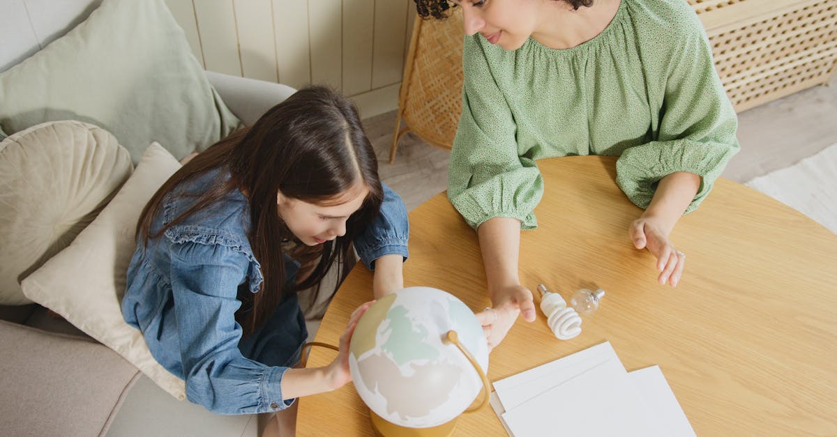 A mother and daughter exploring a globe together at home, promoting education and learning.