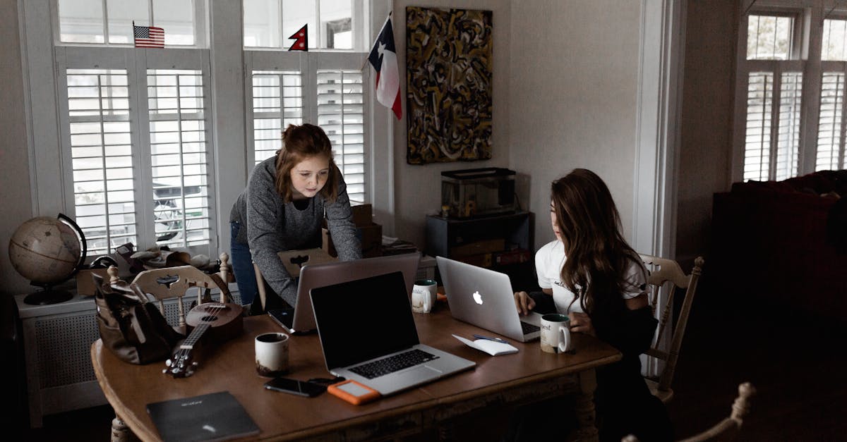 side hustles - Two young women working collaboratively in a cozy home office setting.
