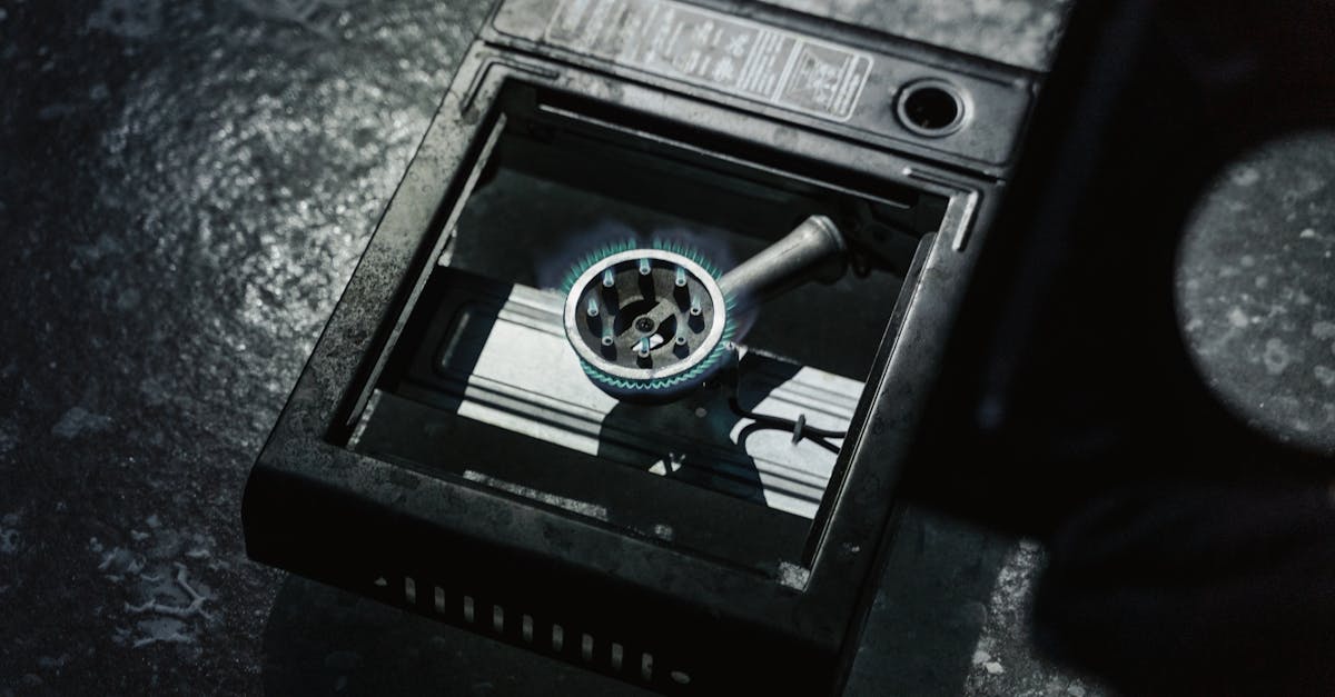 Save Money on Heating - Detailed view of a portable stove with a lit blue flame on a textured surface.
