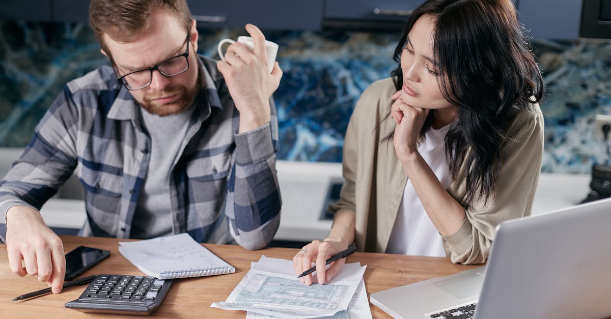 Meal Planning Budget - A couple reviews bills and documents on a laptop while discussing household finances.