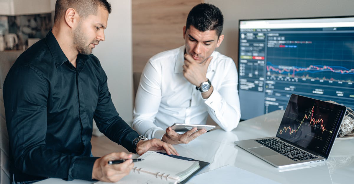 Freelance Writing Income - Two businessmen discussing stock market analytics in a modern office setting.