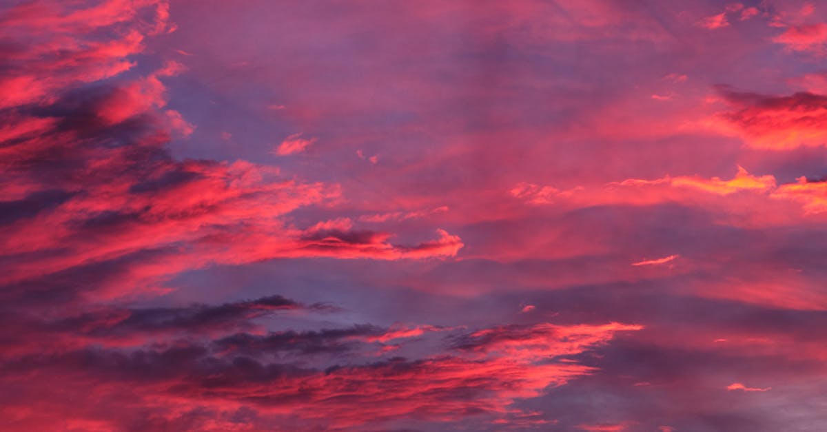Digital Nomad UK - Stunning view of a colorful sunset with vivid pink and purple clouds over Penrith, England.