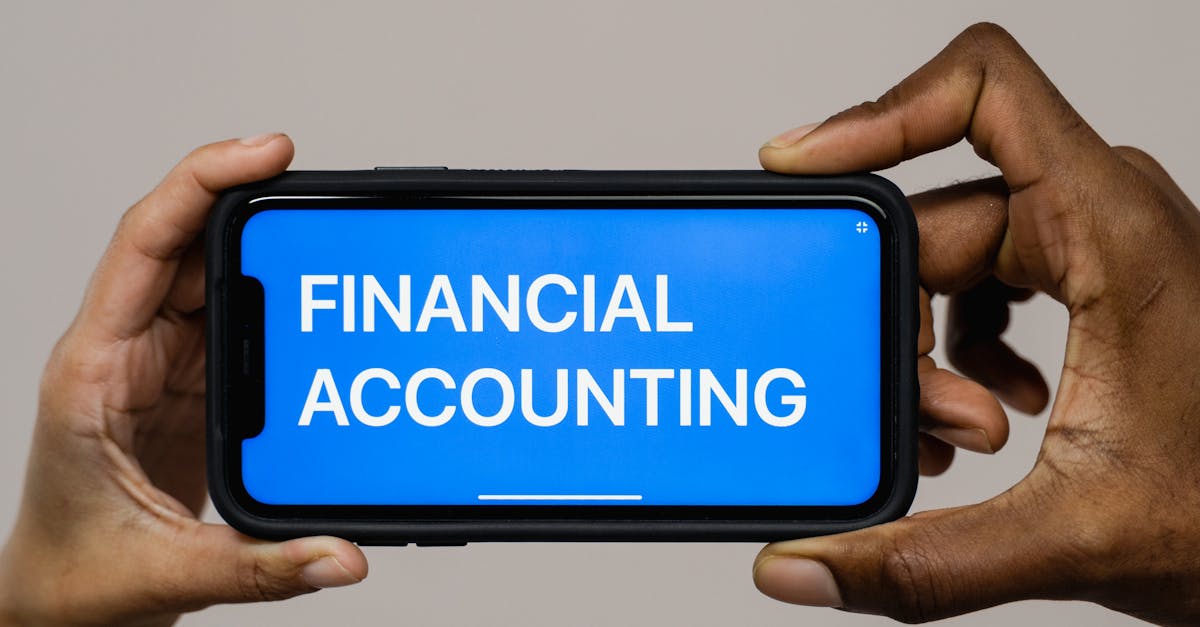 Reducing Monthly Subscriptions - Two people holding a smartphone displaying the text 'Financial Accounting'.