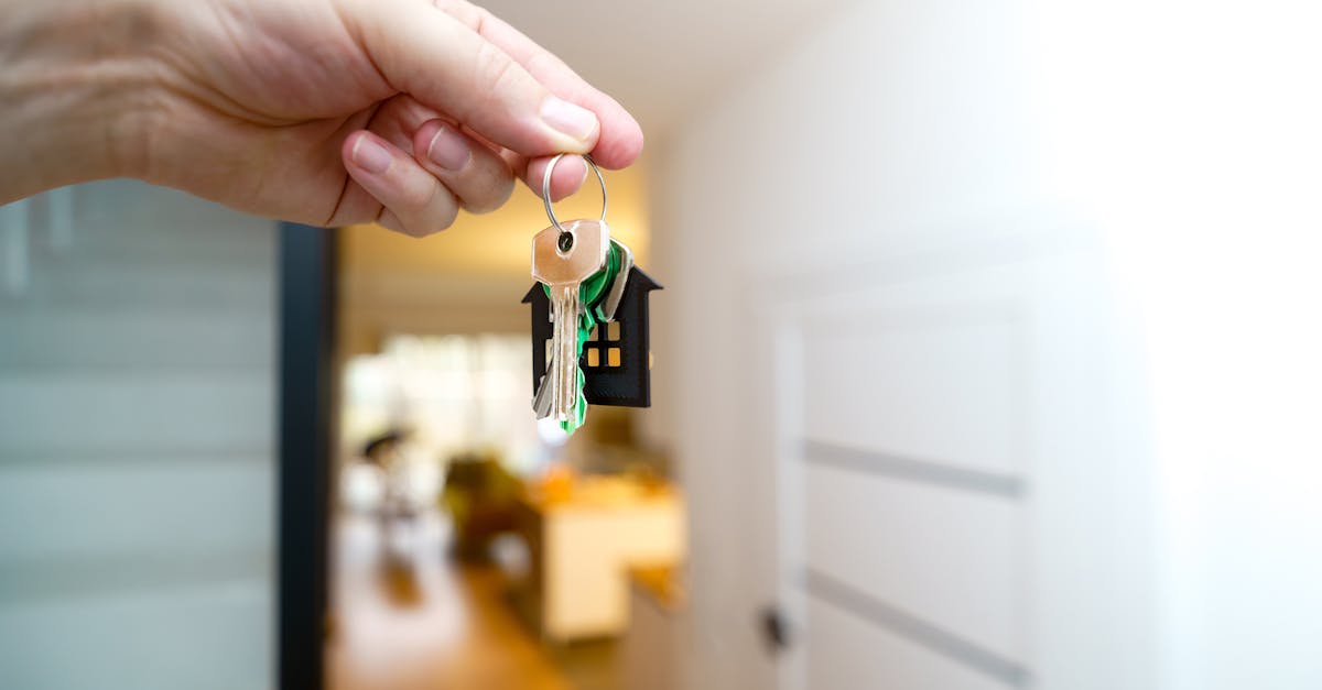 Rent a Room Scheme - A hand holding house keys inside a modern apartment, symbolizing new property ownership or rental.