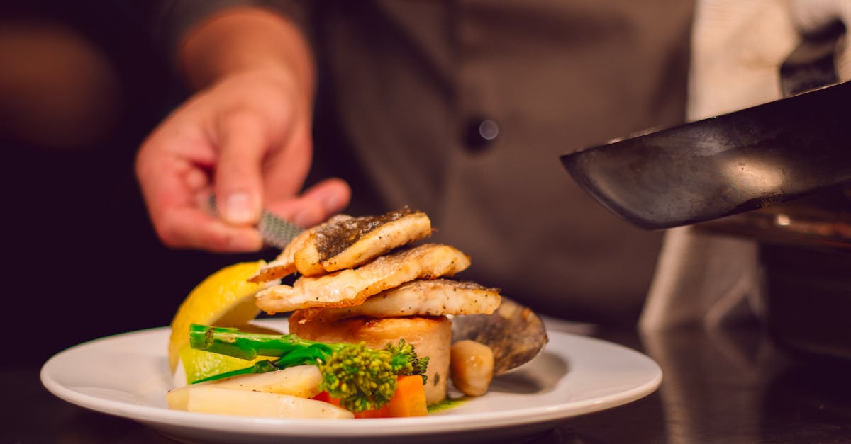 Frugal Gourmet - Gourmet fish dish with vegetables being served by a chef in a UK restaurant.