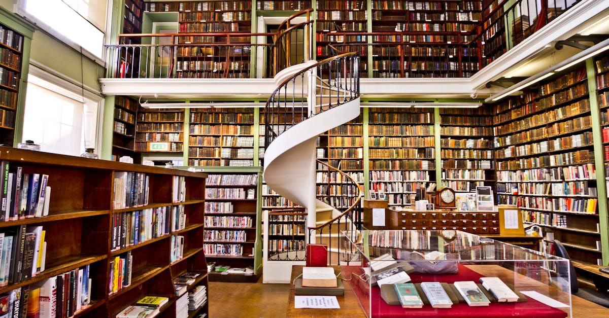 Investing in Vintage Watches - Explore a historic library in England with elegant spiral staircase and extensive bookshelves.