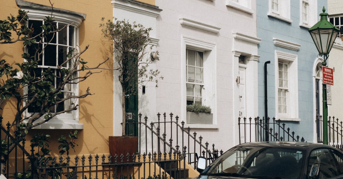 Economical E-Vehicle Ownership - Vibrant pastel townhouses on a sunny London street in Notting Hill.