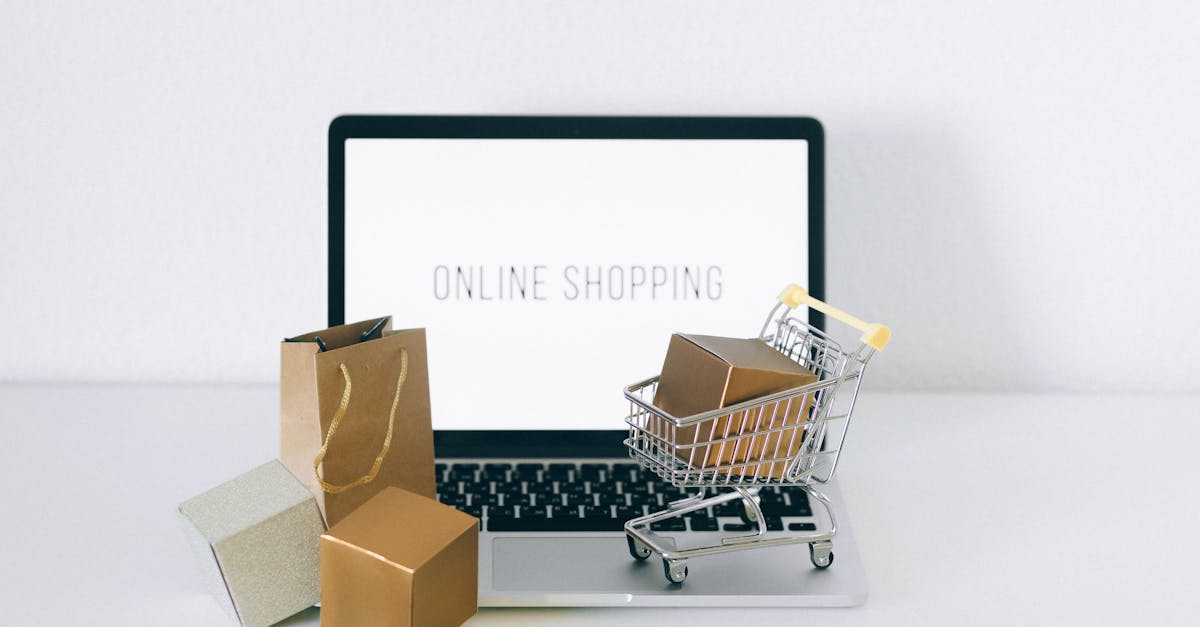 Online Sales in the UK - Laptop displaying online shopping with boxes and cart, representing ecommerce.