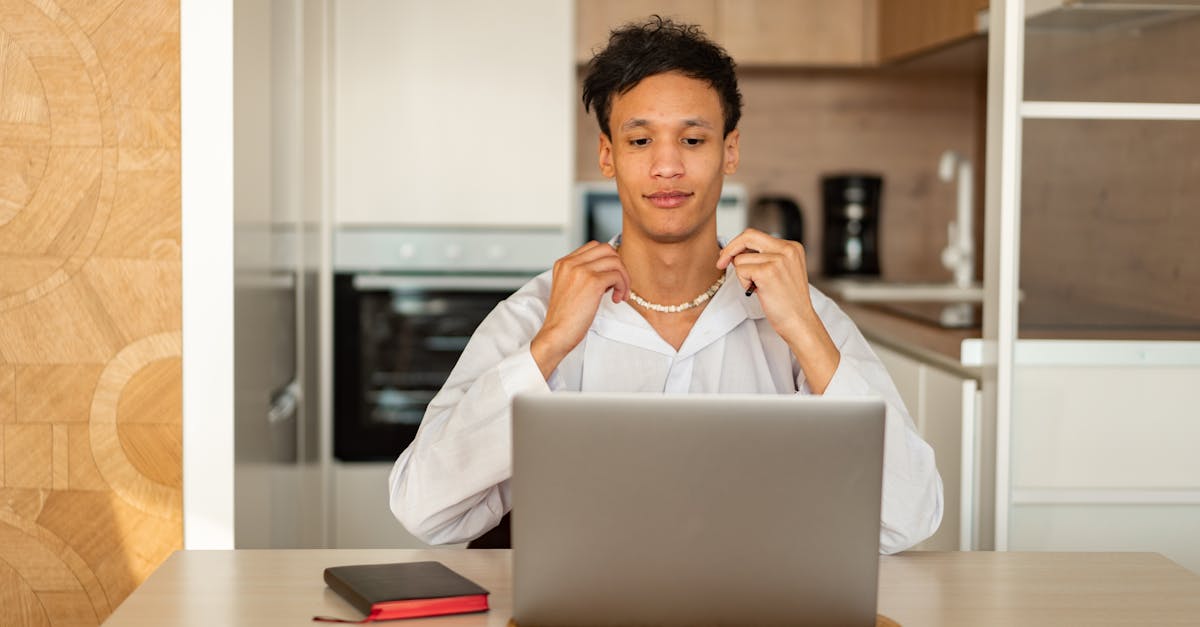 Earning through paid surveys in the UK - A young man in casual attire focuses on his laptop, creating a relaxed home office vibe.