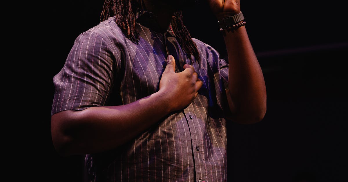 Monetising Streaming Services UK - Black male singer performing on stage passionately holding a microphone.