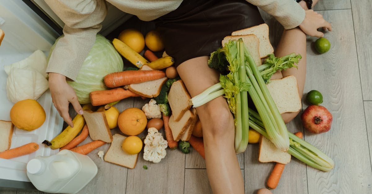 zero waste lifestyle - A woman amidst spilled groceries, highlighting food waste and consumerism with vegetables, fruits, and bread.