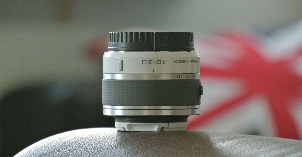 Freebies and Samples UK - Close-up of a NIKON camera lens resting on a leather surface with a Union Jack background.
