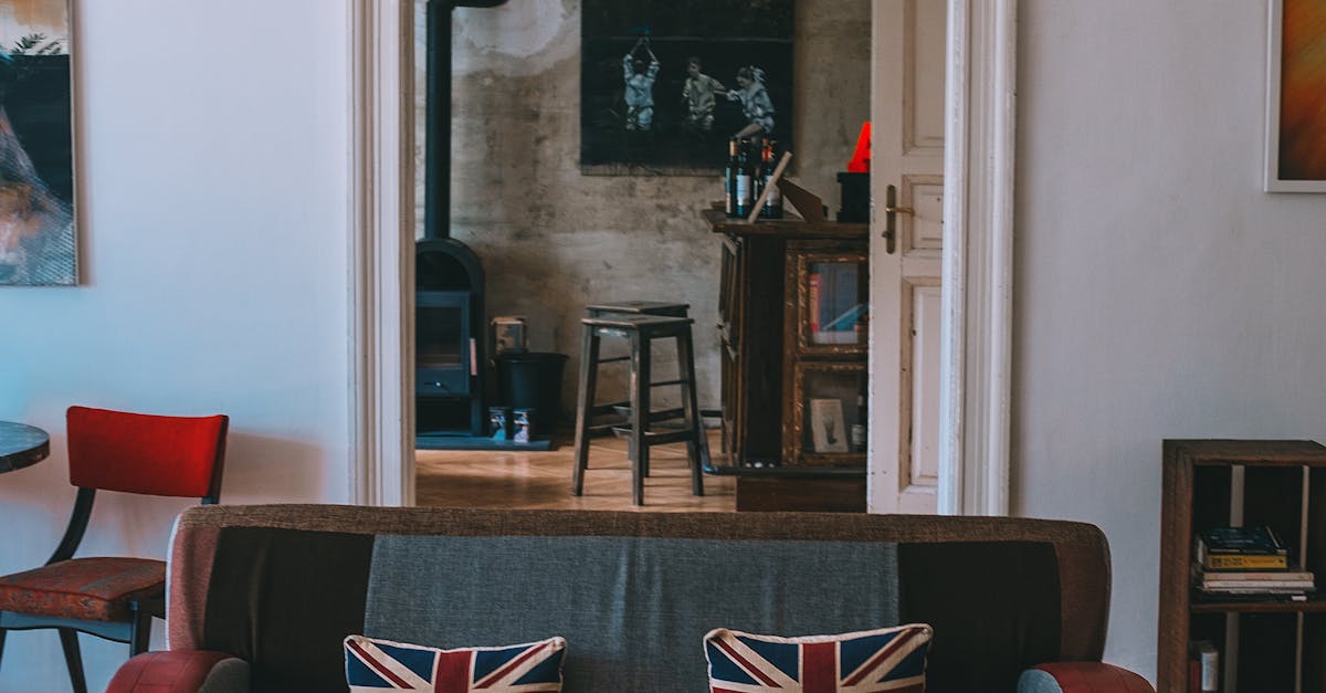 Renting loft space UK - Interior of stylish living room with comfortable couch decorated with United Kingdom flag cushions and wooden furniture and floor